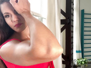 Cute girl so muscular that she plays with her biceps